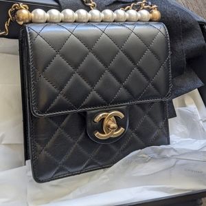 Chanel black quilted lambskin pearl flap bag.